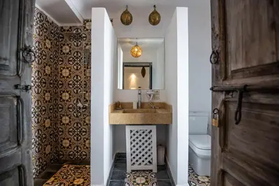 a bathroom with a sink and a toilet at Riad Dar Tmania in Marrakech