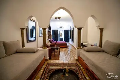 a living room with two beds and a fireplace at Riad Zoraida in Marrakech