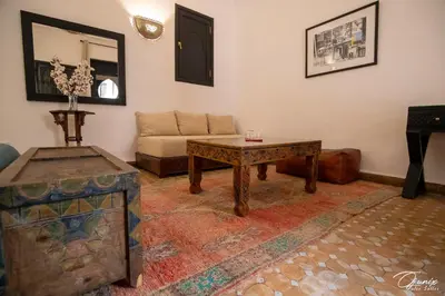 a living room with a couch and a table at Riad Zoraida in Marrakech