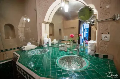a bathroom with two sinks and a mirror at Riad Zoraida in Marrakech