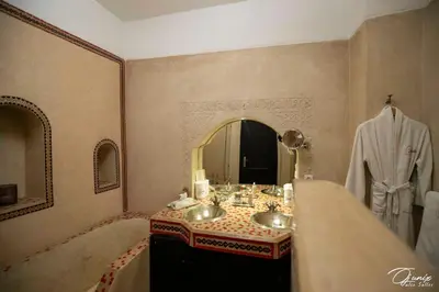 a bathroom with two sinks and a mirror at Riad Zoraida in Marrakech