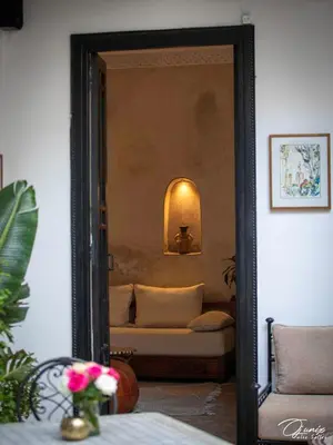 a mirror in a living room with a couch at Riad Zoraida in Marrakech
