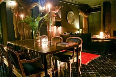 a living room with a table and chairs and a couch at Riad Golfame in Marrakech