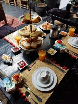 a table topped with food and plates of food at Riad Golfame in Marrakech