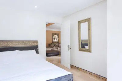 a bedroom with a bed and a mirror at The Ruby Apartment with Private Swimming Pool - Hivernage Quarter - By Goldex Marrakech in Marrakech