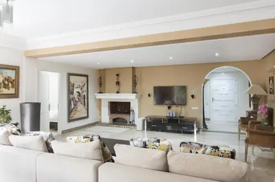 a living room with white furniture and a fireplace at The Ruby Apartment with Private Swimming Pool - Hivernage Quarter - By Goldex Marrakech in Marrakech