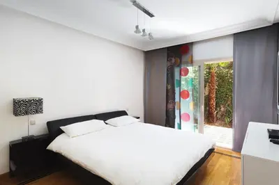 a bedroom with a white bed and a window at The Ruby Apartment with Private Swimming Pool - Hivernage Quarter - By Goldex Marrakech in Marrakech
