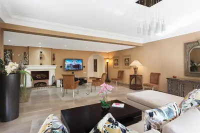 a living room with a couch and a fireplace at The Ruby Apartment with Private Swimming Pool - Hivernage Quarter - By Goldex Marrakech in Marrakech