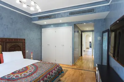 a bedroom with a bed and a large closet at The Ruby Apartment with Private Swimming Pool - Hivernage Quarter - By Goldex Marrakech in Marrakech