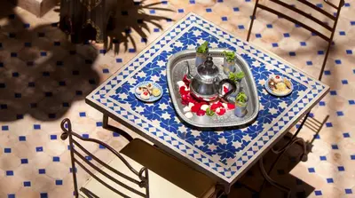 a table with a tea pot and food on it at Riad Arbre Bleu in Marrakech