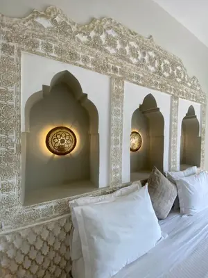 a bed with two lights on top of it at La Villa Des Golfs & PinkCactus in Marrakech