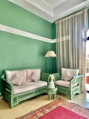 a living room with two chairs and a couch at La Villa Des Golfs & PinkCactus in Marrakech