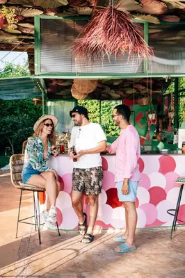 a group of three people standing in front of a bar at La Villa Des Golfs & PinkCactus in Marrakech