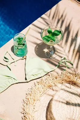 a table with a glass of water and a drink at La Villa Des Golfs & PinkCactus in Marrakech