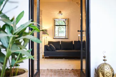 a living room with a couch and a mirror at Riad Rafaele & SPA in Marrakech