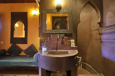 a bathroom with a sink and a mirror at Riad Marrakiss in Marrakech