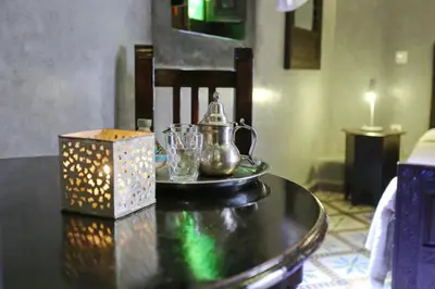 a table with a tea kettle and a box on it at Riad Marrakiss in Marrakech