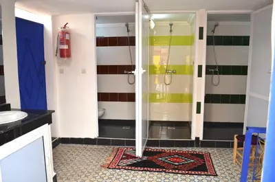 a bathroom with a shower and a sink at Mosaic Hostel in Marrakech