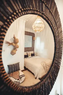 a reflection of a bedroom with a bed in a mirror at Riad Dar Elma And Spa in Marrakech
