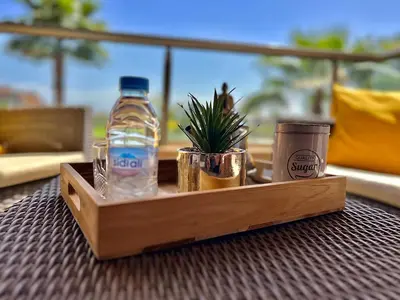 a wooden tray with a bottle of water on a table at Marrakech golf City prestigia in Marrakech