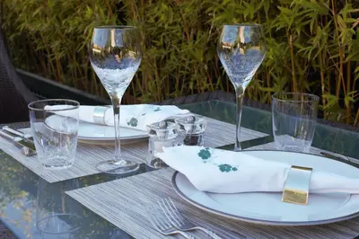 a table with wine glasses and plates on it at Riad Idra in Marrakech