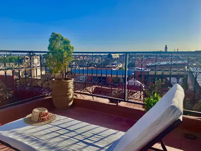 a hat sitting on a table on a balcony at Riad Prada in Marrakech