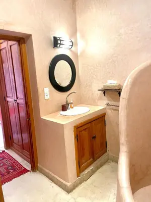 a bathroom with a sink and a mirror on the wall at Riad Prada in Marrakech