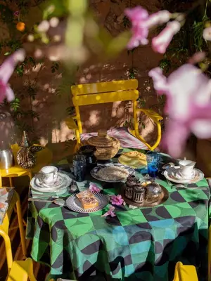 a green and white table with food on it at Riad Tibibt in Marrakech