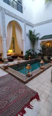 a lobby with a swimming pool in a building at Riad Dar Saad - Hammam & Spa in Marrakech