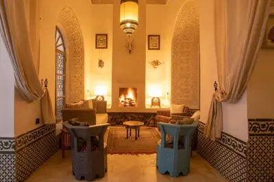 a room with a fireplace and a living room with a couch at Riad Dar Saad - Hammam & Spa in Marrakech