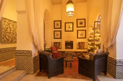 a living room with two chairs and a christmas tree at Riad Dar Saad - Hammam & Spa in Marrakech