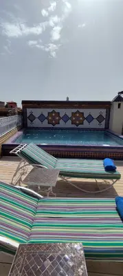 a group of surfboards sitting on top of a swimming pool at Riad Dar Saad - Hammam & Spa in Marrakech