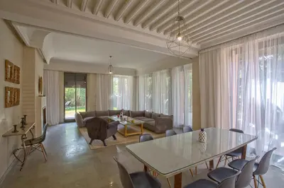 a living room with a table and a couch at Villa Berbère Domaine des Kasbahs in Marrakech