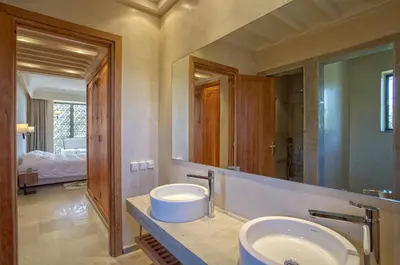 a bathroom with two sinks and a large mirror at Villa Berbère Domaine des Kasbahs in Marrakech