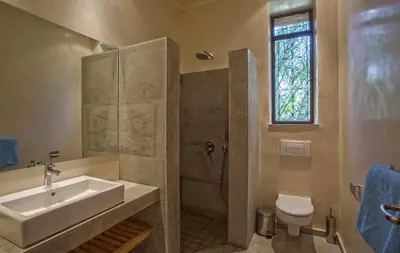 a bathroom with a sink and a shower with a toilet at Villa Berbère Domaine des Kasbahs in Marrakech