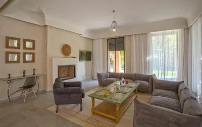 a living room with a couch and a table at Villa Berbère Domaine des Kasbahs in Marrakech