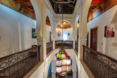 a chandelier hangs from a hallway in a house at Maison Do in Marrakech