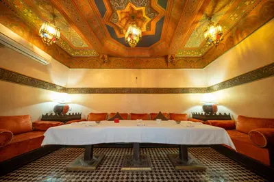 a room with a table in a room with a ceiling at Maison Do in Marrakech