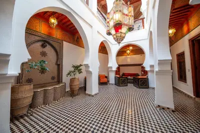 a lobby with a chandelier and a tiled floor at Maison Do in Marrakech