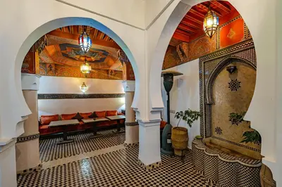 a living room with an archway with a couch at Maison Do in Marrakech