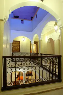 a bedroom with a balcony with a bed in it at Riad CHERRATA in Marrakech