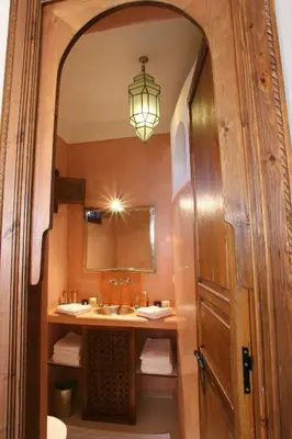 a bathroom with a sink and a mirror at Riad CHERRATA in Marrakech