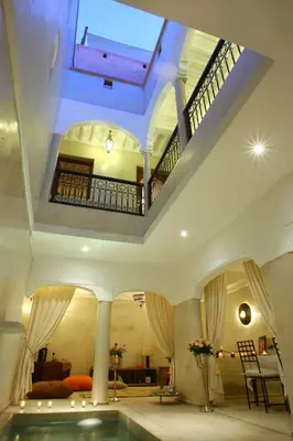 a large room with a swimming pool in a house at Riad CHERRATA in Marrakech