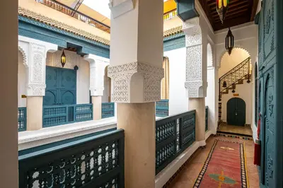a corridor of a building with a balcony at Dar Alhambra Riad Medina in Marrakech
