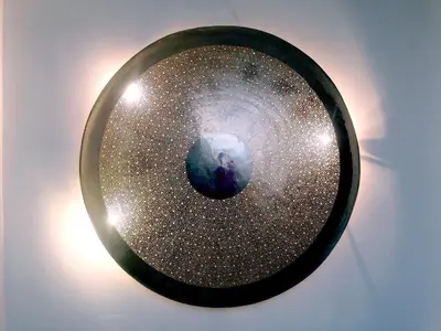 a mirror with a picture of the earth in it at Medina Dream Riad Exclusive Rental in Marrakech