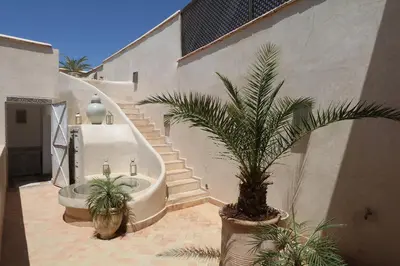 a bathroom with a bath tub and a palm tree at Medina Dream Riad Exclusive Rental in Marrakech