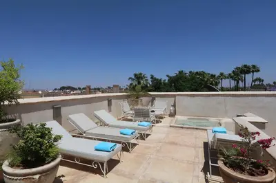 a patio with lounge chairs and a swimming pool at Medina Dream Riad Exclusive Rental in Marrakech