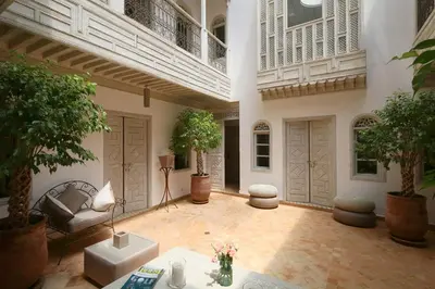 a large living room with plants and a balcony at Medina Dream Riad Exclusive Rental in Marrakech