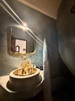 a bathroom with a sink and a mirror at Riad Djemanna in Marrakech