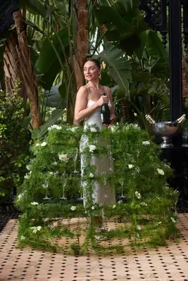 a woman is standing in a garden with flowers at Selman Marrakech in Marrakech